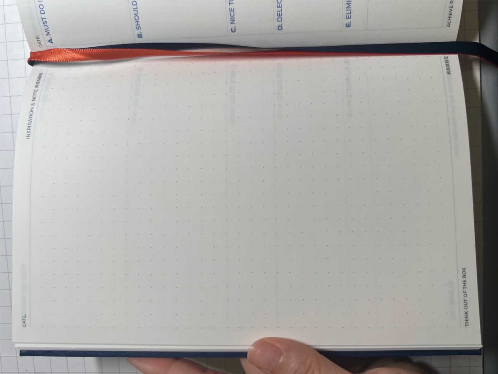 Custom notebook MOQ example showing dot-grid inner pages redesigned for a corporate planner